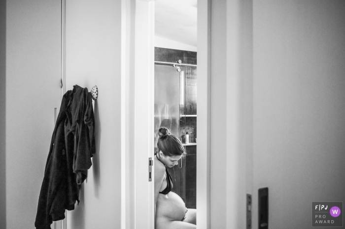 Photo by: <a href="https://www.fpja.com/documentary-family-photography-contests/ta%C3%ADs-motta/campinas/2102417">Taís Motta - Brazil</a> A quiet moment for a mom as she is in labor at the hospital | Campinas Birthing Photographer