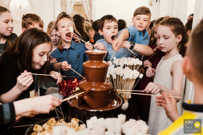 Photo by: <a href="https://www.fpja.com/documentary-family-photography-contests/elena-petrova/saint-petersburg/2102541">Elena Petrova - Russia</a> Children enjoy marshmallows and a chocolate fountain at a birthday party | Russia Party Photographer