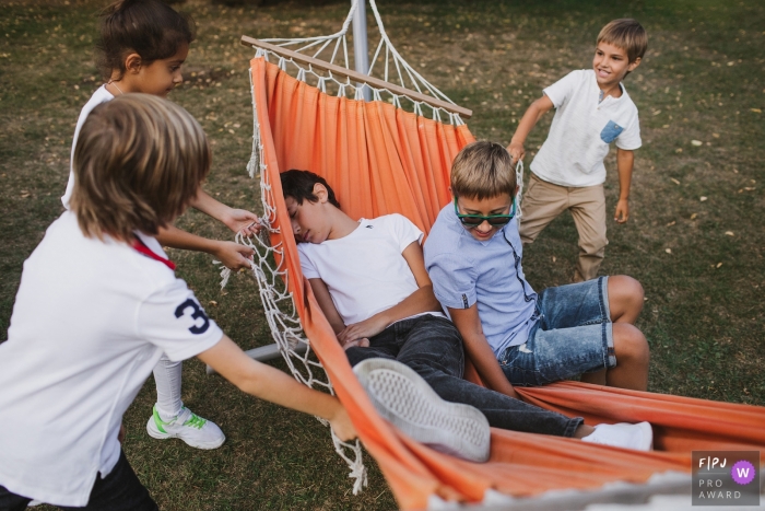 Photo by: <a href="https://www.fpja.com/documentary-family-photography-contests/elena-petrova/saint-petersburg/2102549">Elena Petrova - Russia</a> Shuvalovka Family Photography | Kids having fun on a hammock