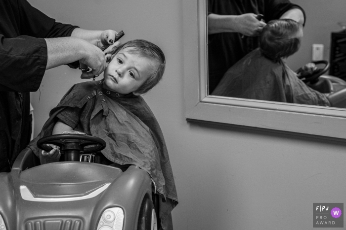 Connecticut family photography of a boy's First haircut... a little unsure of the whole situation.