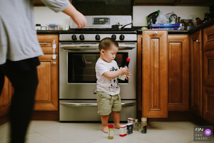 Toddler pulls everything out of the spice cabinet | Los Angeles family photography