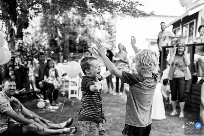 Photo by: <a href="https://www.fpja.com/documentary-family-photography-contests/ron-storer/seattle/2102777">Ron Storer - United States</a> Black and white photo of kids celebrating at a party | Seattle family photography