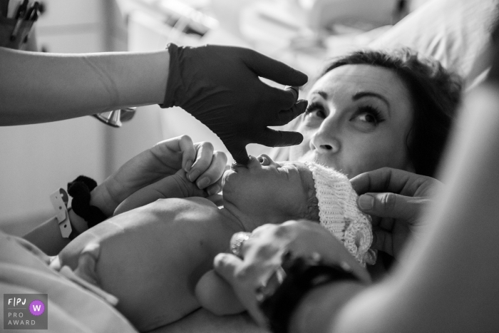 Photo by: <a href="https://www.fpja.com/documentary-family-photography-contests/adeline-leonti/montreal/2104218">Adeline Leonti - Canada</a> Montreal Quebec doctor is checking the baby's sucking reflex at Hospital Pierre Boucher