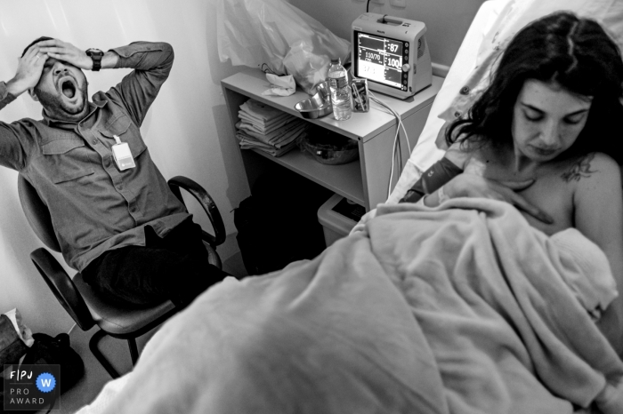 Photo by: <a href="https://www.fpja.com/documentary-family-photography-contests/rafael-rosa/rio-grande-do-sul/2104246">Rafael Rosa - Brazil</a> Rio Grande do Sul couple in the hopsital after the birth of their child who is nursing and father is looking pretty tired.