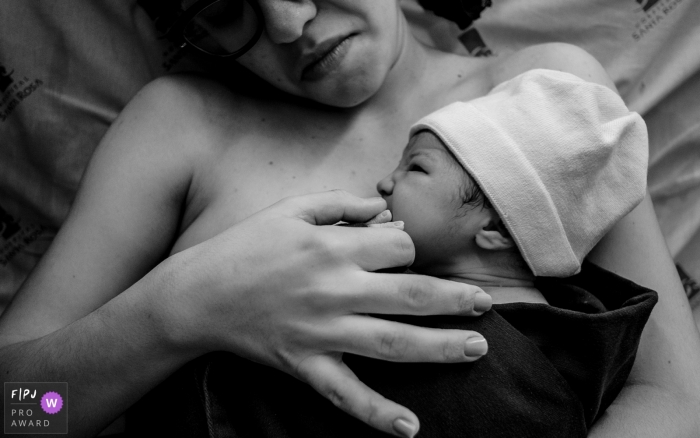 Hospital Santa Rosa photo of mom and baby and the big hands that protect the small hands