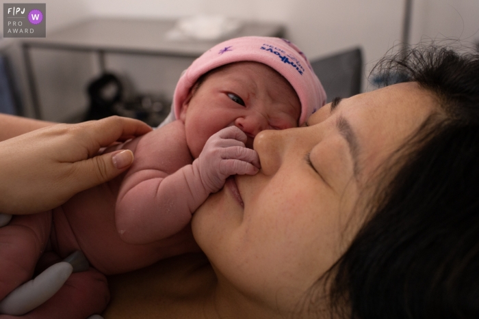 Maternidade São Luiz birth image of a mother enjoying the touch of her new baby.