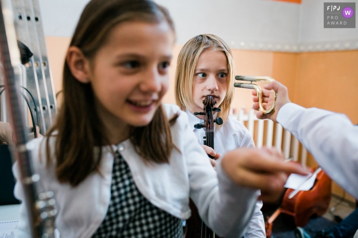 Photo by: <a href="http://fpja.com/documentary-family-photography-contests/polona-avanzo/ljubljana/2102794">Polona Avanzo - Slovenia</a> Slovenia kids having fun with instruments while waiting to perform on stage.