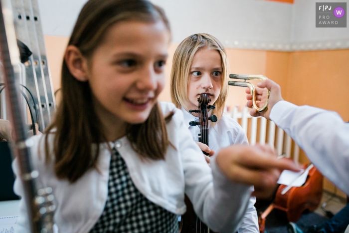 Slovenia kids having fun with instruments while waiting to perform on stage.