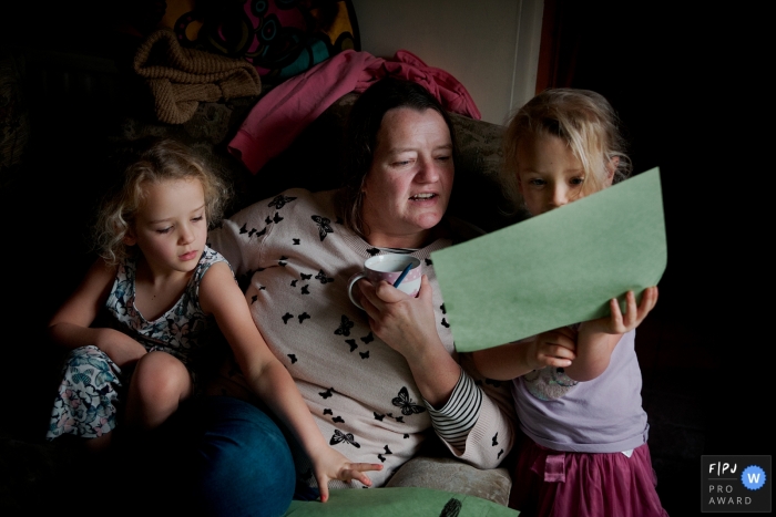 Dorset Family Photojournalism | Sisters showing their mother their drawings