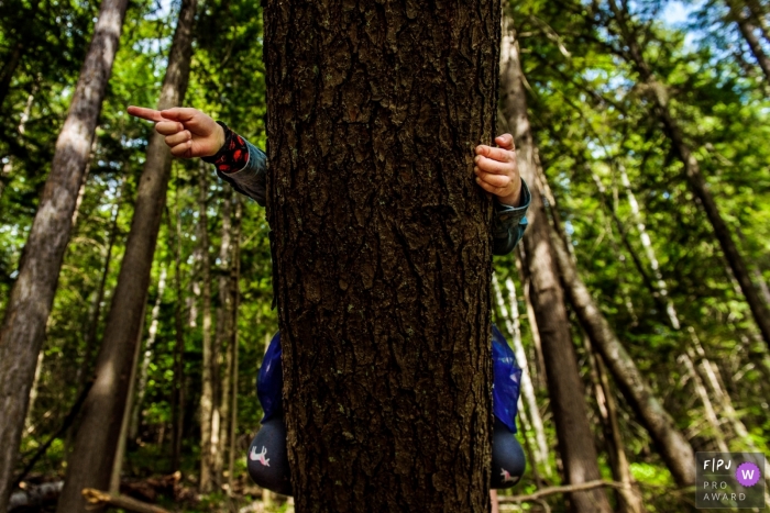 Photo by: <a href="https://www.fpja.com/documentary-family-photography-contests/bobbi-barbarich/british-columbia/2103095">Bobbi Barbarich - Canada</a> British Columbia Girl climbs tree and points from her perch