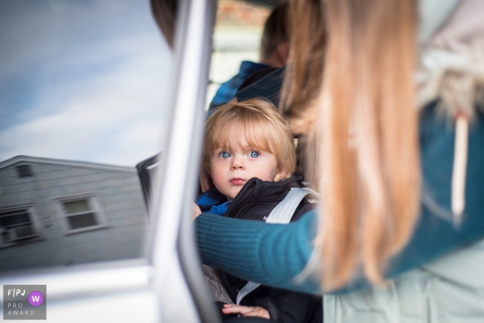 New Jersey Mom getting daughter buckled into the car 