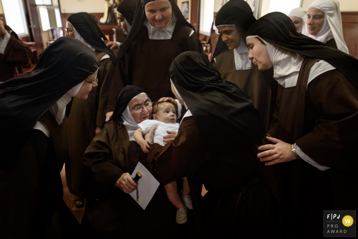 Italian nuns embrace boy soon after he is baptized.