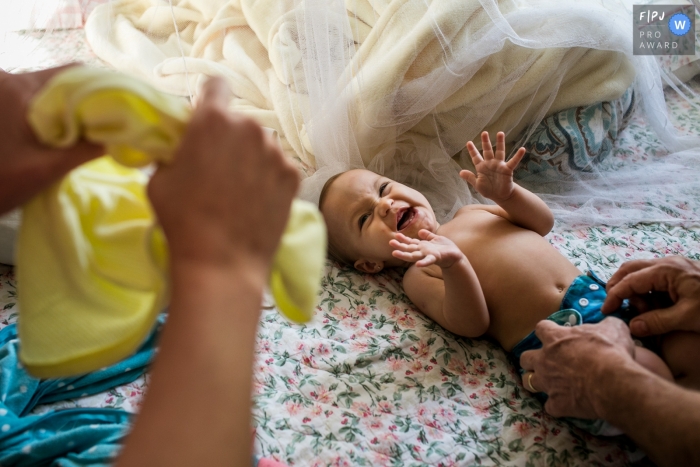 Belo Horizonte Minas Gerais child reacts with joy to parents during a change of clothes