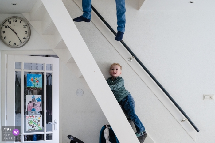 Photo by: <a href="https://www.fpja.com/documentary-family-photography-contests/marjolijn-maljaars/zuid-holland/2103594">Marjolijn Maljaars - Netherlands</a> Zuid Holland Netherlands Boy is just hanging around the stairs at home