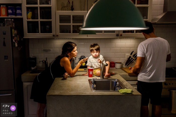 Sao Paulo Brazil boy and family preparing Saturday breakfast in the kitchen