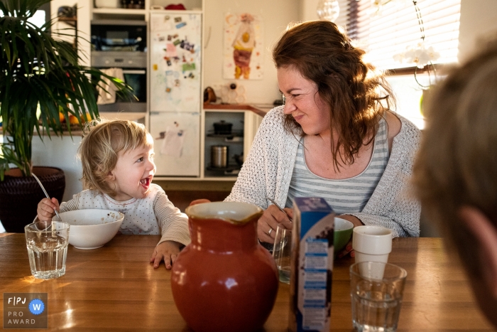 Photo by: <a href="https://www.fpja.com/documentary-family-photography-contests/ruth-wytinck/east-flanders/2103764">Ruth Wytinck - Belgium</a> East Flanders mom is having a snack with her child at the table - day in the life