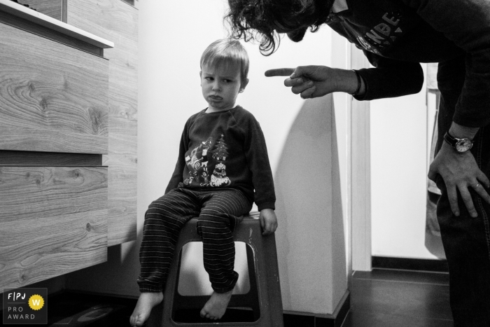 Photo by: <a href="https://www.fpja.com/documentary-family-photography-contests/joshua-dhondt/antwerpen/2103985">Joshua Dhondt - Belgium</a> A young boy being scolded and set down at his home in Belgium.