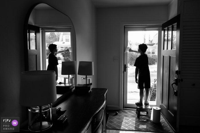 Madison Wisconsin Child washes front door window at home