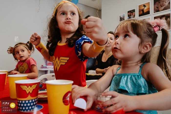 Photo by: <a href="https://www.fpja.com/documentary-family-photography-contests/thiago-braga/florianopolis/2104752">Thiago Braga - Brazil</a> Birthday girl, playing superhero with friends, celebrating at home in Santa Catarina, Brazil.