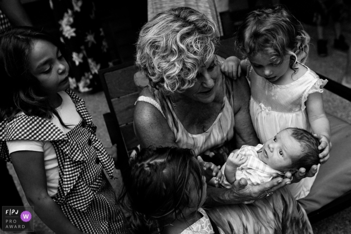 Photo by: <a href="https://www.fpja.com/documentary-family-photography-contests/ron-storer/seattle/2104841">Ron Storer - United States</a> Seattle grandma holding baby as other children look on