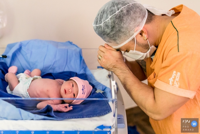 Photo by: <a href="https://www.fpja.com/documentary-family-photography-contests/ellen-brito/sao-paulo/2105195">Ellen Brito - Brazil</a> Dad is thankful and happy for the arrival of his new baby at the Hospital e Maternidade Sao Luiz