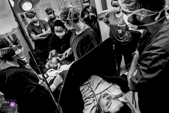 Photo by: <a href="https://www.fpja.com/documentary-family-photography-contests/eduardo-bedran/minas-gerais/2105525">Eduardo Bedran - Brazil</a> Mother waiting to see her new baby that was just delivered at Vila da Serra