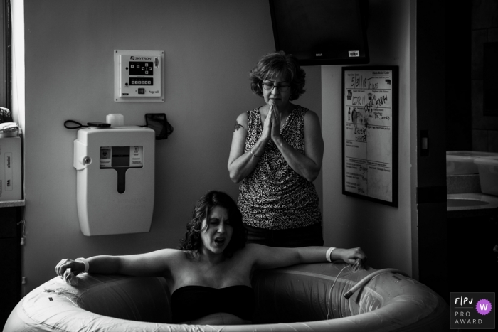 Photo by: <a href="https://www.fpja.com/documentary-family-photography-contests/chanda-williams/atlanta/2105797">Chanda Williams - United States</a> Atlanta Medical Center birth photography of a mother praying over her baby.