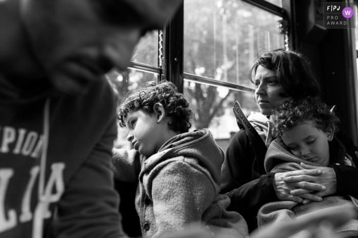 Photo by: <a href="https://www.fpja.com/documentary-family-photography-contests/lavinia-nitu/modena/2105046">Lavinia Nitu - Italy</a> A family of 4 is traveling back home after a day of adventures | Italy family day-trip photography