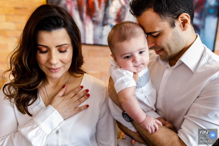 Photo by: <a href="https://www.fpja.com/documentary-family-photography-contests/priscilla-mondo/sao-paulo/2105126">Priscilla Mondo - Brazil</a> Sao Paulo Brazil baby christening service photo from a church service.