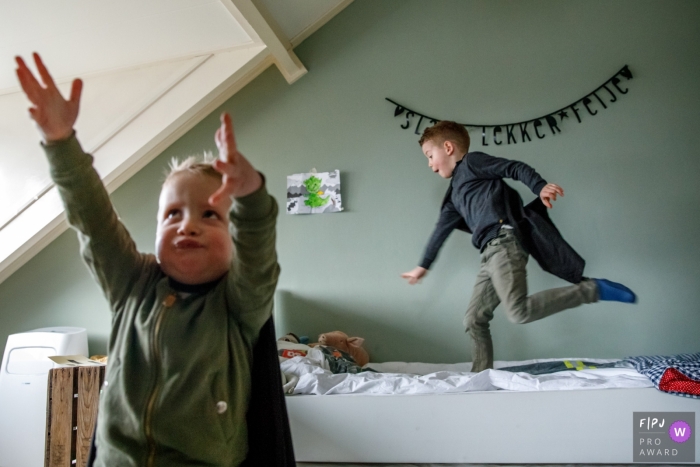 Photo by: <a href="https://www.fpja.com/documentary-family-photography-contests/indra-simons/overijssel/2106152">Indra Simons - Netherlands</a> Superhero boys play in their room during a family photo shoot in the Netherlands