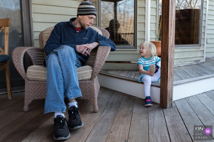 Connecticut family photo session of dad and daughter sharing a moment on the porch.