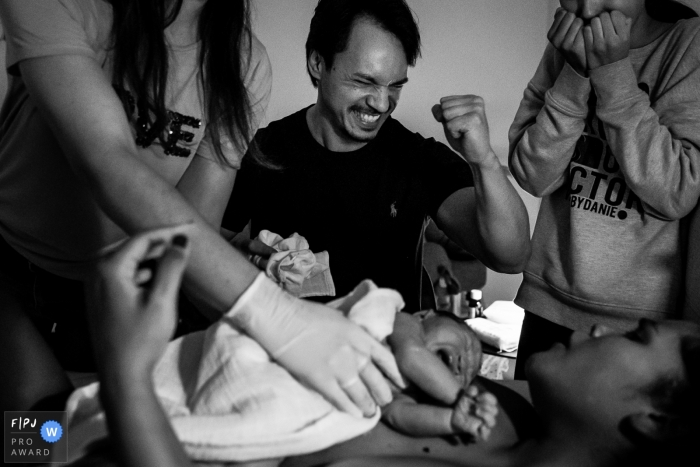Photo by: <a href="https://www.fpja.com/documentary-family-photography-contests/louise-van-den-broek/flevoland/2106879">Louise van den Broek - Netherlands</a> Flevoland Home Birth Image of dad extremely happy of the arrival of the baby