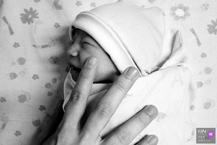 Photo by: <a href="https://www.fpja.com/documentary-family-photography-contests/lisandro-castro/cuiab%C3%A1/2107993">Lisandro Castro - Brazil</a> Hospital Santa Rosa birth image of the newborn being touched on their face