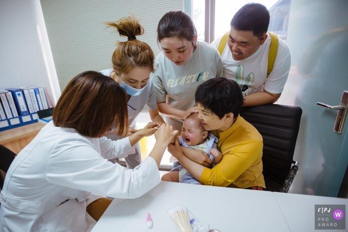 Shanxi Documentary Family Photo of a Baby crying when drawing blood Shanxi Documentary Family Photographer | Baby crying when drawing blood