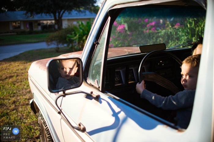 Photo by: <a href="https://www.fpja.com/documentary-family-photography-contests/samantha-moore/sarasota/2106865">Samantha Moore - United States</a> Sarasota, FL Documentary Family Photography | Little man is ready to take daddy's truck for a spin