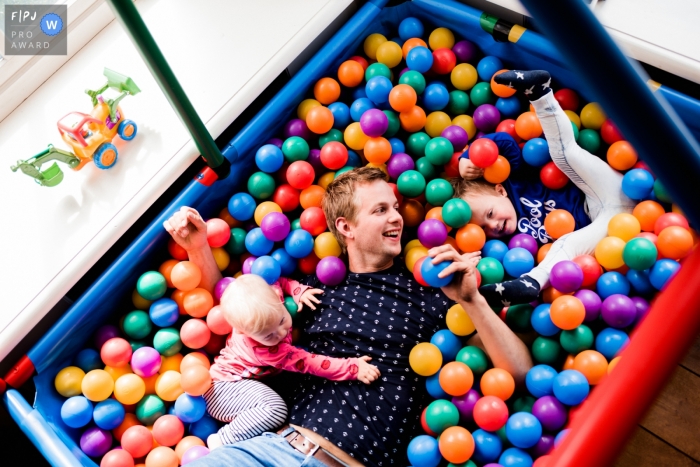 Photo by: <a href="https://www.fpja.com/documentary-family-photography-contests/karen-velleman/groningen/2106925">Karen Velleman - Netherlands</a> Groningen Family Photo of dad and kids in a ball pit