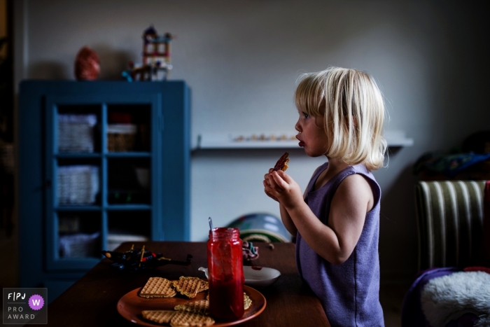 Denmark Documentary Family photo of girl eating waffles and jam Denmark Documentary Family photo of girl eating waffles and jam