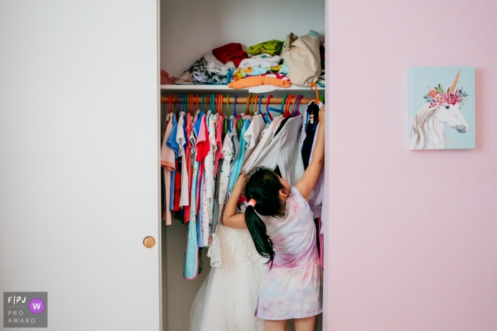 Chicago Family image of a girl looking in her closet for the perfect dress to wear