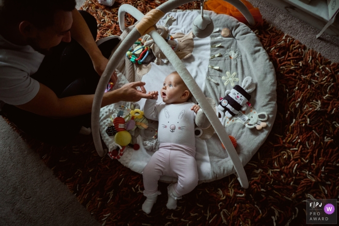 Lancashire Family Photography | Young baby holding tight to her father's hand