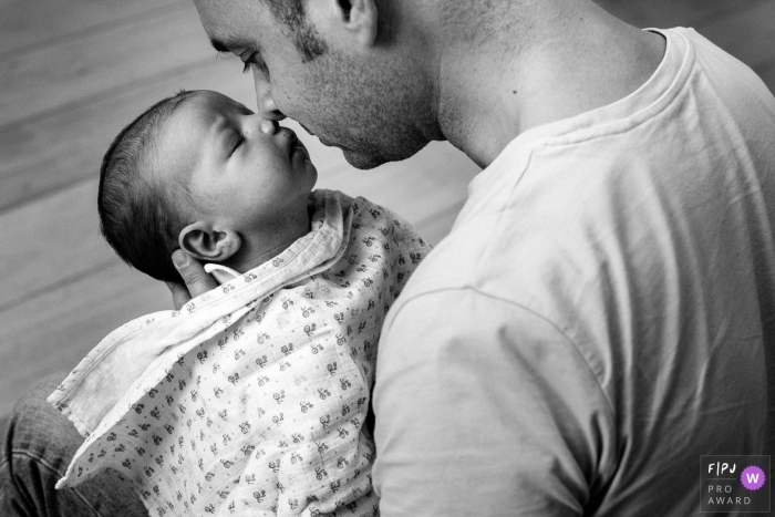Photo by: <a href="https://www.fpja.com/documentary-family-photography-contests/marine-poron/paris/2107564">Marine Poron - France</a> Paris family photo of infant being held by dad going nose to nose