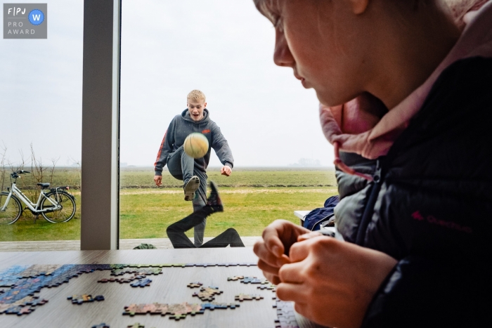 NRW Documentary Family Session with pictures created as Kids play ball outside and one is inside doing a puzzle NRW Documentary Family Session | Kids play ball outside and one is inside doing a puzzle
