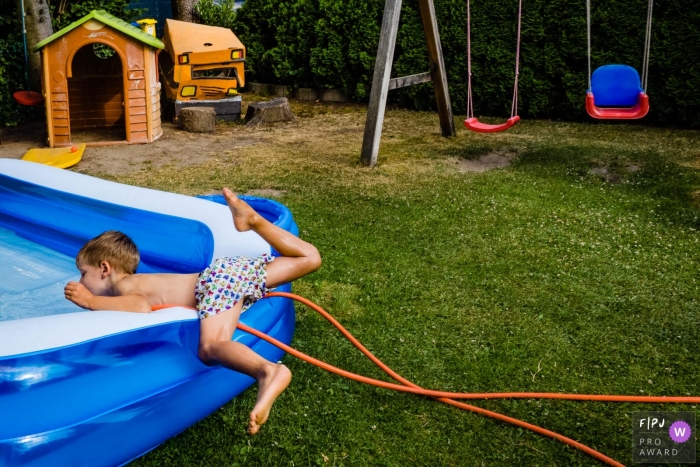 Dusseldorf documentary family capture of a boy about to go head first into the pool