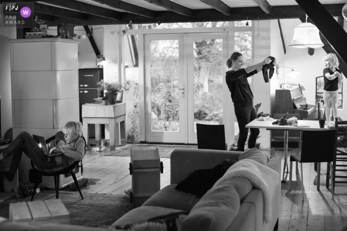 Drenthe Documentary Family photo of a toddler girl on the table resisting the clothing her mother has picked out for her