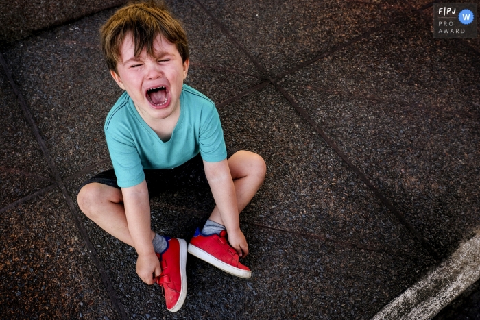 Minas Gerais Family image of a young boy not so happy, filled with tears