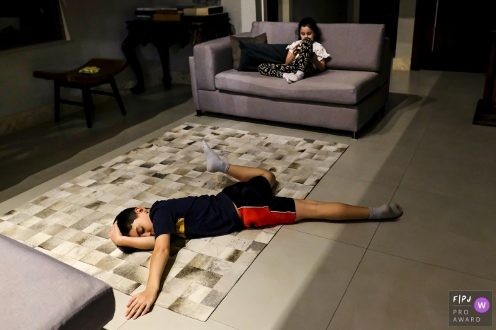 Photo by: <a href="https://www.fpja.com/documentary-family-photography-contests/eduardo-bedran/minas-gerais/2107738">Eduardo Bedran - Brazil</a> Minas Gerais Documentary Family Photography | young man exhausted and sprawling himself out on the floor