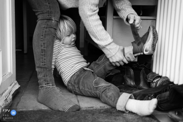 Cambridgeshire Documentary Family picture of mum taking girl's shoes off