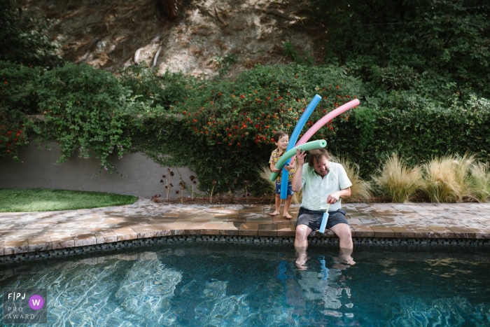 Los Angeles Documentary Family Photo showing a dad gets attacked by pool noodles Los Angeles Documentary Family Photo | dad gets attacked by pool noodles