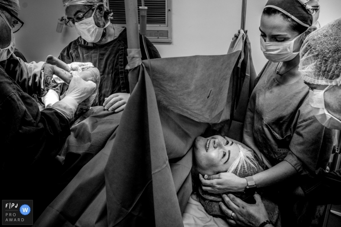 MG documentary-style black and white birthing photo shoot of mom in operating room at Hospital Santa Rosa