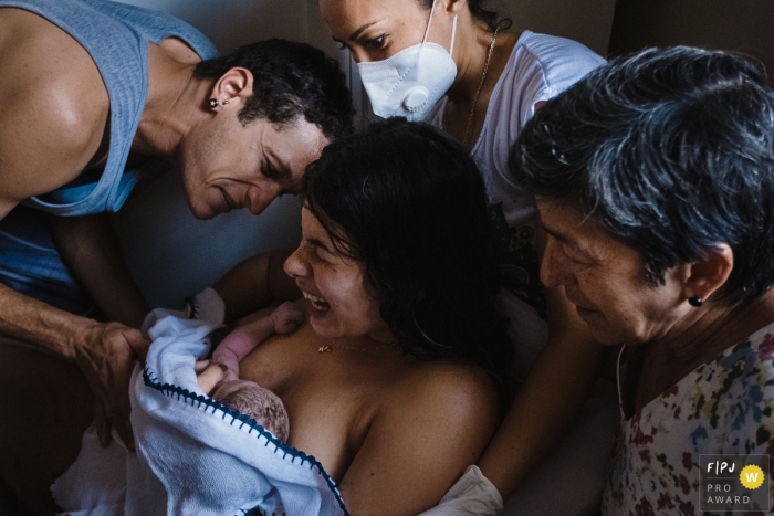 Brazilian Family is surrounded by the new baby born into the family with pure joy