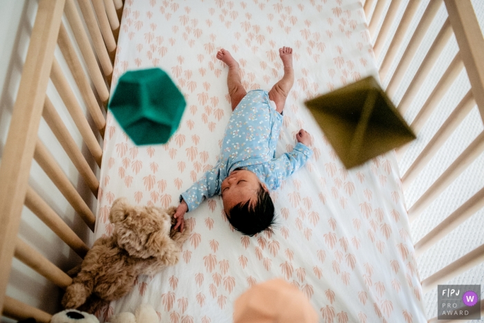 Washington DC Family photo of a newborn sleeping in her bed